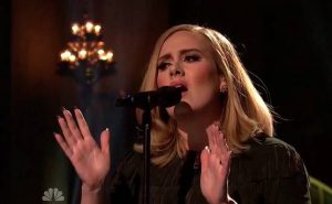 adele singing into a microphone