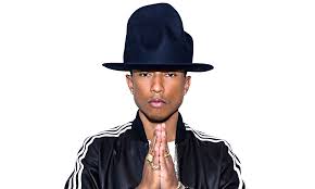 pharrell with large hat and holding hands like he's praying