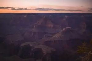 red rocky canyon spreading into the distance at dusk