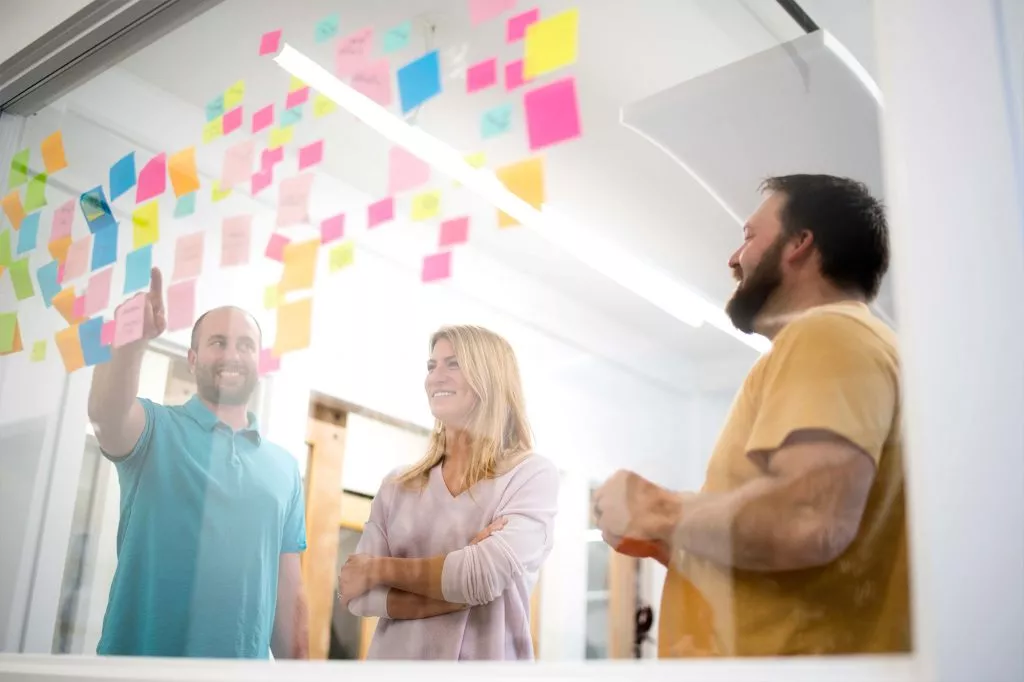 oneupweb digital marketing team strategizes with sticky notes in a meeting room