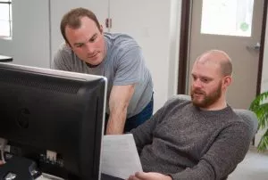 Two professionals going over paperwork in an office