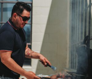 CEO Fernando Meza grilling outside for Oneupweb employees.