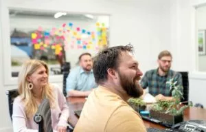 a group of marketers work in a conference room for a brand