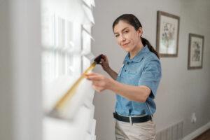 an aire serve employee measuring the home