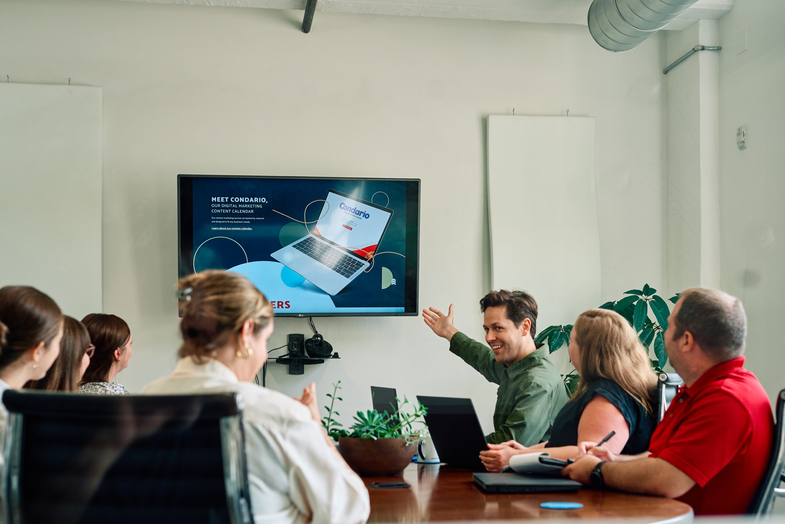 oneupweb employees in a conference room